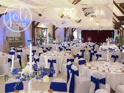 Reception setting featuring blue and white ceiling drapes