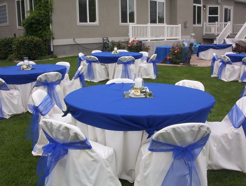 Round tables styled in royal blue with matching chair covers