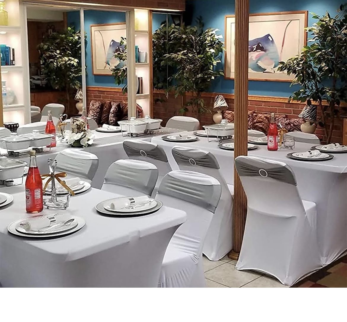 Elegant white stretch chair covers in a decorated dining room