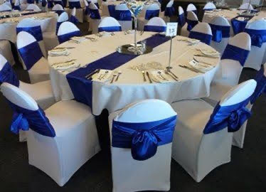Blue chair bows with white table cloths at a wedding